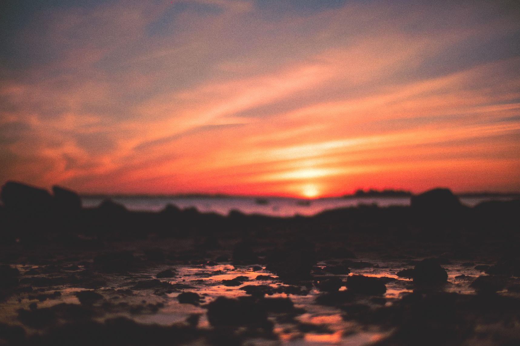 Au dessus du coucher de soleil, les nuages s'additionnent en longue ligne