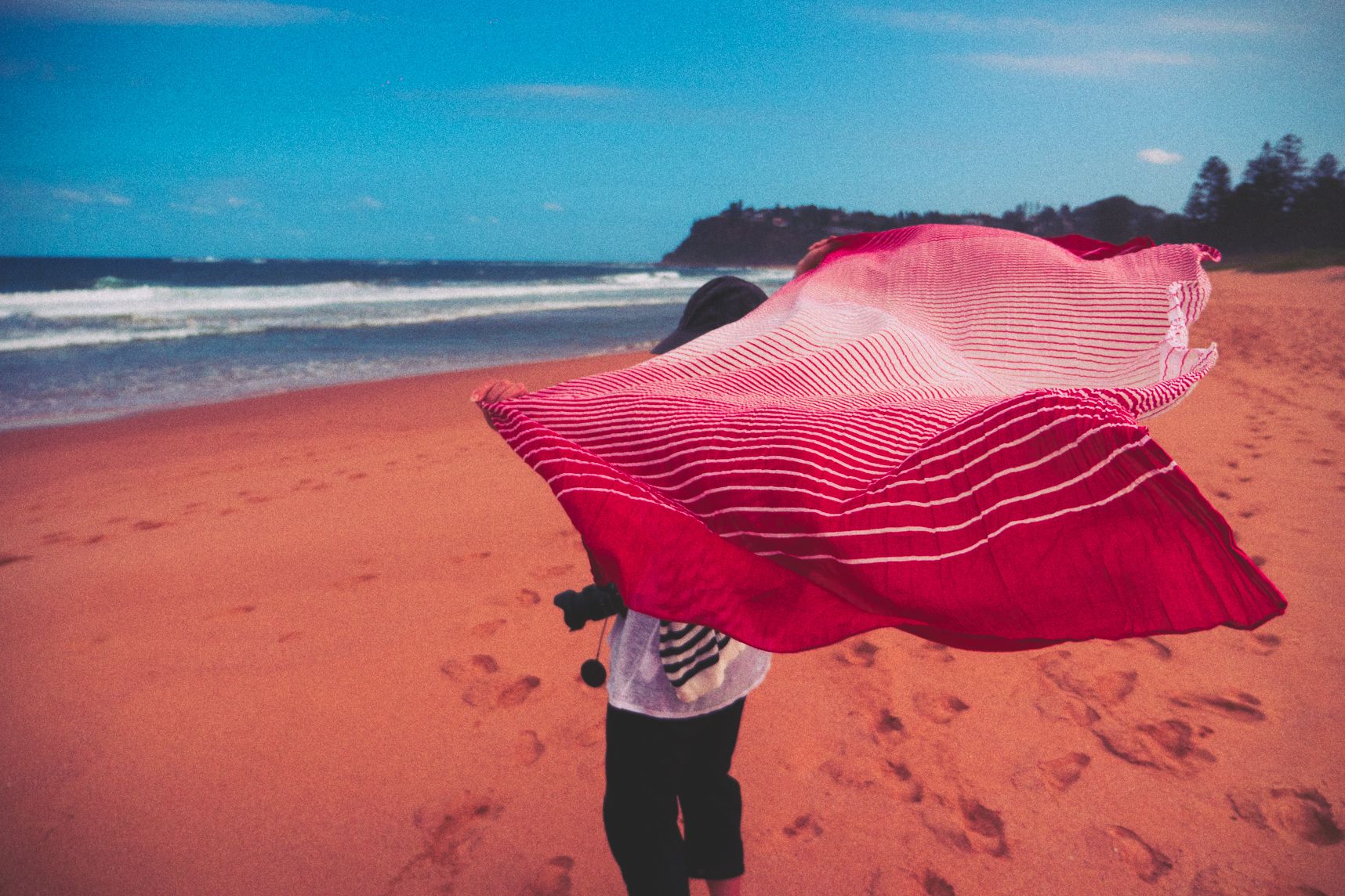 Sur la plage devant la mer, le foulard vole dans le vent
